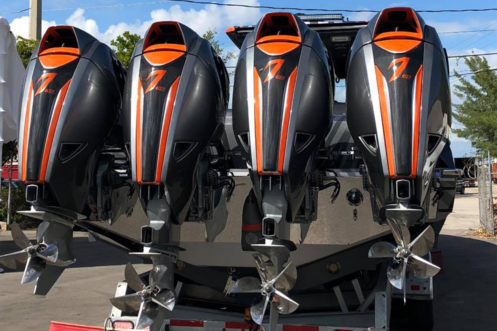 Back of custom boat on trailer with 4 outboard motors.